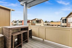 a balcony with a table and some houses at 5787 Coffey Villa Perfect for Traveling Professional in Garden City