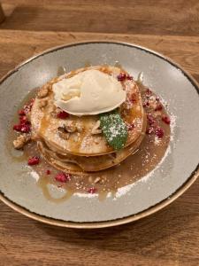 a plate of pancakes with ice cream on top at Time Cafe & Penzion in Příbram