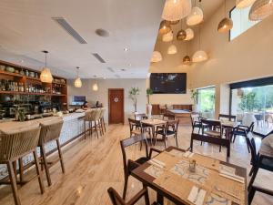 a restaurant with tables and chairs and a bar at Villa Familiar con Alberca Privada en Tulum Country Club Riviera Maya in Akumal