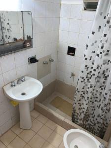 a bathroom with a sink and a shower with a toilet at Chalet MAX in Bialet Massé