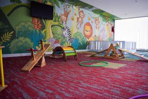 a childrens play room with a mural on the wall at Howard Johnson Plaza & Convention Center Spa La Plata in La Plata