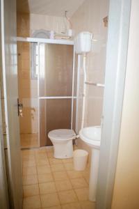 La petite salle de bains est pourvue de toilettes et d'un lavabo. dans l'établissement Brisa do Mar Hotel, à Arroio do Sal