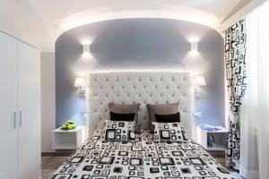 a bedroom with a large bed with a large headboard at Amalfi Apartments Design centro storico in Amalfi