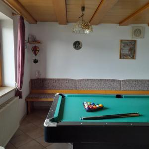 a room with a pool table and a bench at Gästehaus am Muttelsee in Tettnang