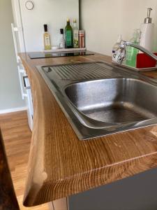 a kitchen counter with a stainless steel sink at Fullt utrustat Minihus på landet in Västerhaninge