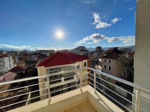 a balcony with a view of a city at Downtown Apartment in Korçë