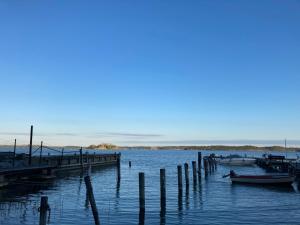 a group of boats docked at a dock in the water at Fullt utrustat Minihus på landet in Västerhaninge