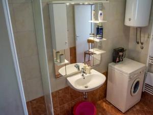 a bathroom with a sink and a toilet and a mirror at Apartment Lokvica in Sukošan +31 photos