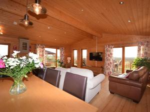 a living room with a white couch and a table at 4 Bed in Lincoln 59449 