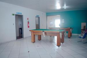 a room with a ping pong table in it at Brisa do Mar Hotel in Arroio do Sal