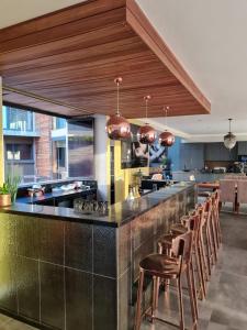 a large kitchen with a bar with stools at Luxury Home located on Pinnacle Point Golf Estate in Mossel Bay