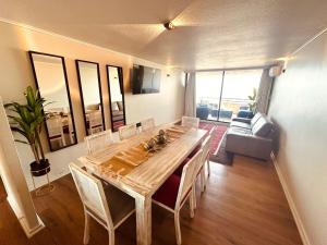 a dining room with a wooden table and chairs at Calafquen Viña del mar in Viña del Mar