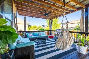 a patio with a hammock and a grill at Luxe Home-Designer BTHRM-Covered Deck-Weber Grill in San Antonio