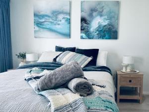 a bedroom with a bed with a blanket on it at U2 at Moana Beach Esplanade - Exclusive 2 Bdrm Apt - WiFi - Spa - Pet Friendly in Moana
