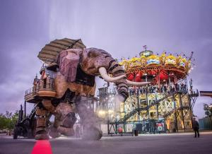 an elephant statue in front of a carnival ride at * Cosy & Netflix Proche Centre * in Nantes