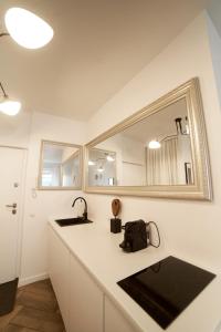 a white bathroom with two sinks and a mirror at Wawahome studio old town in Warsaw