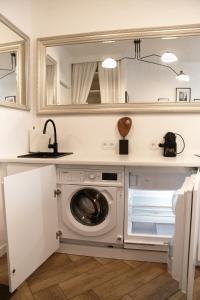 a kitchen with a washing machine and a sink at Wawahome studio old town in Warsaw