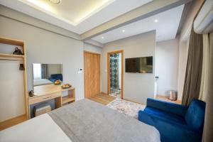 a bedroom with a bed and a blue couch at StayHub in Istanbul