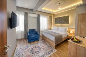 a hotel room with a bed and a blue chair at StayHub in Istanbul