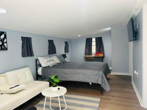 um quarto com uma cama e um sofá branco em Cozy New Mfd Home near Lake Norman em Denver