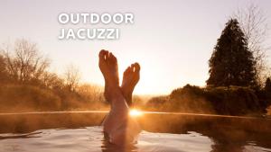 a person in the water with their feet in the water at Sauna & Jakuzzi Kisleshegy Dörgicse Vendégház in Dörgicse