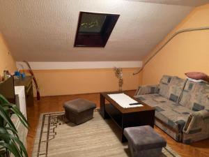 a living room with a couch and a table at LAVRNIĆ in Apatin