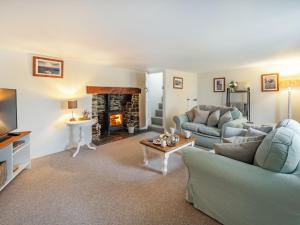 a living room with two couches and a fireplace at 2 Bed in South Molton 86611 in Dennington