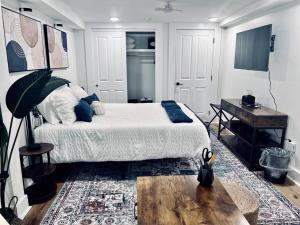 a bedroom with a bed and a table and a desk at Urban Oasis in OTR Near Casino & Bell Event Centre! in Cincinnati