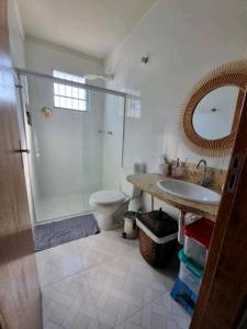 a bathroom with a shower and a sink and a toilet at Casa do Renato in Anchieta