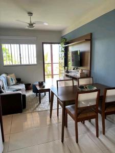 a living room with a table and a couch at Casa do Renato in Anchieta