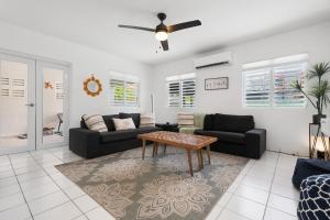 a living room with a couch and a table at walk to beach or swim in the pool, 4 bedrooms home in Humacao