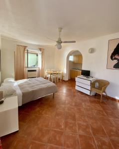 a bedroom with a bed and a table and a kitchen at Agriturismo L'Ulivo E Il Mare in Moneglia