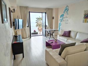 a living room with a couch and a table at Mar dei Poeti - Luxury Suites in Riposto