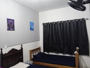 ein Schlafzimmer mit 2 Betten und einem schwarzen Vorhang in der Unterkunft ParkFlat in Sorocaba