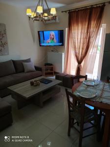 a living room with a couch and a table at Joanna 's Loft in Kissamos