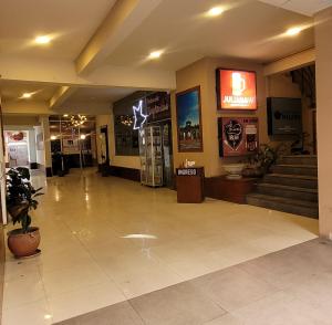 a lobby with stairs and a sign in a building at Hotel Madrid in La Paz