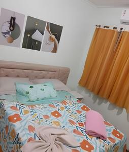 a bedroom with a bed with a bedspread with fish on it at Pousada Souza Familiar in Porto Velho