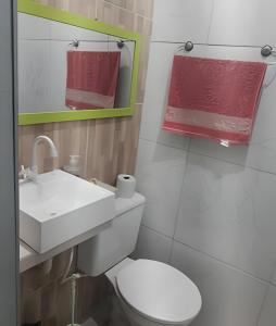 Łazienka z białą toaletą i umywalką w obiekcie Pousada Souza Familiar w mieście Porto Velho