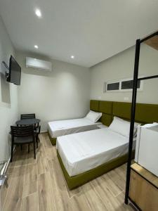 Rúm í herbergi á Hotel Rai