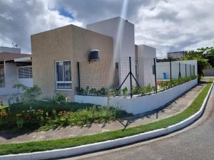 ein Haus mit einem Zaun davor in der Unterkunft Casa praia do frances in Marechal Deodoro