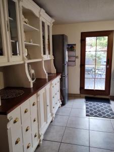 a kitchen with white cabinets and a refrigerator at U Joli in Jugowice +7 photos