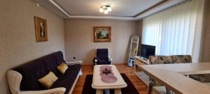 a living room with a couch and a table at Centar apartment in Belišće