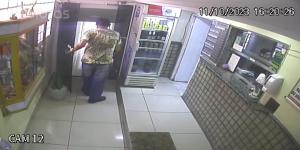 a man is standing in front of a refrigerator at Hospedaria Monumento in Sao Paulo