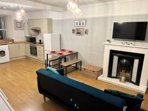 a living room with a couch and a fireplace at Harris Apartment in Montrose