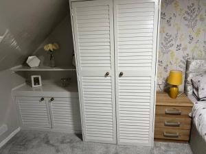 1 dormitorio con cama y armario blanco en Harris Apartment, en Montrose