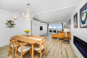 a dining room and living room with a table and chairs at Oceanfront Jewel - Remodeled to Perfection in Rehoboth Beach