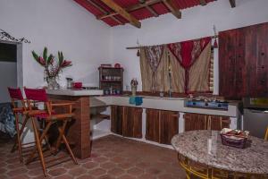 a kitchen with a counter and a table in it at Cabañas Gonzalez in Salcoatitán