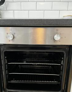 an oven with its door open in a kitchen at Home In The Heart Of Southsea in Portsmouth