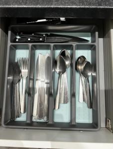 a tray of utensils in a drawer in an oven at Home In The Heart Of Southsea in Portsmouth