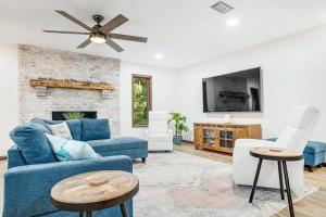 a living room with a blue couch and a fireplace at Buccaneer Bungalow on Amelia Isle! in Fernandina Beach